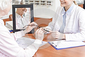 Senior cheerful woman choosing eyewear