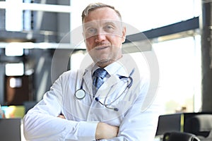 Senior chief physician in white robe with stethoscope