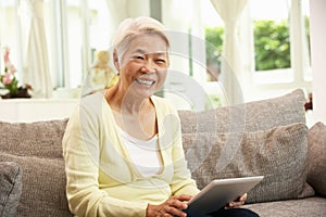 Senior Chinese Woman With Tablet Computer