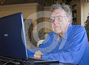 Senior citizen on computer photo