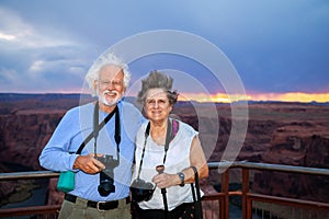 Senior Citizen Couple at Horseshoe Bend Overlook at Sunset on a Windy Day