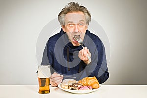 Senior citizen eating sweet cakes, croissant and donut as unhealthy meal