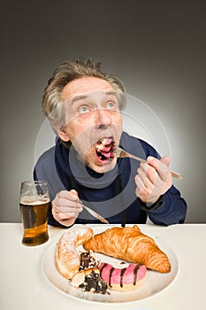 Senior citizen eating sweet cakes, croissant and donut as unhealthy meal