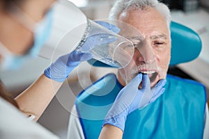 Senior citizen keeping his mouth open for a dental x-ray