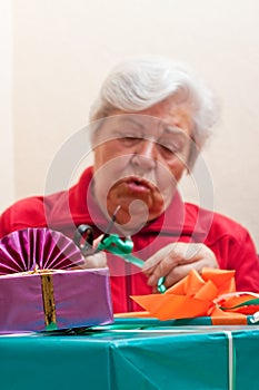 A senior citizen wrap or unpack presents, closeup