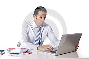 Senior confident businessman working at computer office desk isolated on white background