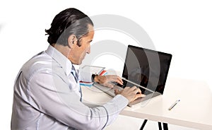 Senior confident businessman working at computer office desk isolated on white background