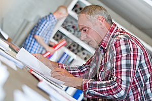 Senior contractor at desk doing paperwork photo