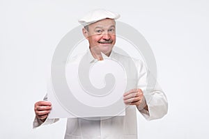 Senior cook man holding sign speech bubble smiling delighted