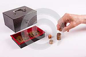 Senior counts money of an old cashbox