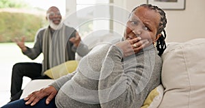 Senior, couple and angry on couch with conflict, argument or marriage problems in living room of home. Elderly, black