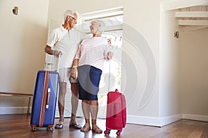 Senior Couple Arriving At Summer Vacation Rental