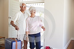 Senior Couple Arriving At Summer Vacation Rental