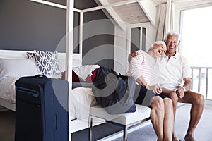 Senior Couple Arriving At Summer Vacation Rental