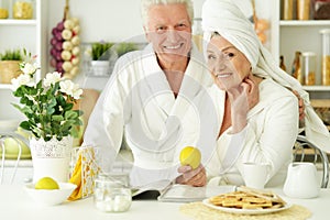 Senior couple in a bathrobes with tea
