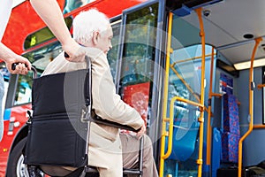 Senior Couple Boarding Bus Using Wheelchair Access Ramp photo