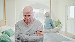 Senior couple, breakup and fight on bed in conflict, disagreement or dispute at home. Frustrated elderly man in cheating