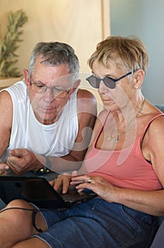 Senior couple browsing computer photo