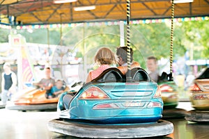 Senior couple in the bumper car at the fun fair