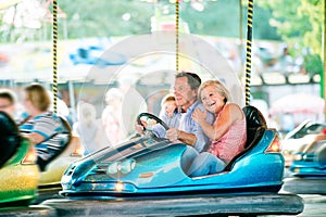 Senior couple in the bumper car at the fun fair