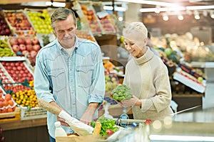 Senior Couple Buying Groceries in Supermarket