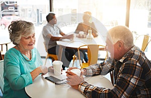 Senior couple, cafe and talking together, relationship bonding and discussion for retirement plan with married people