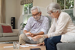 Senior couple calculating expenses