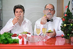Senior couple celebrating new year eating grapes. Spanish new year tradition.