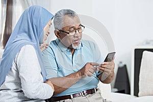 Senior couple checking the smartphone