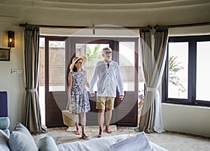 Senior couple checking in to a resort