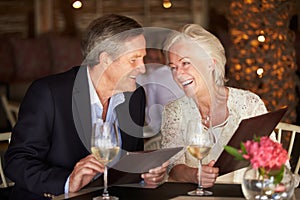 Senior Couple Choosing From Menu In Restaurant