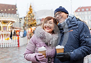 Senior couple with coffee at christmas market