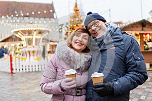 Senior couple with coffee at christmas market
