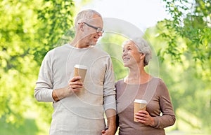 Senior couple with coffee cups natural background