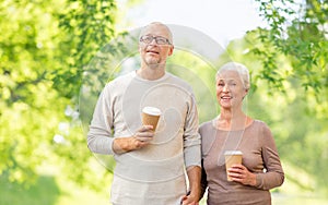 Senior couple with coffee cups natural background