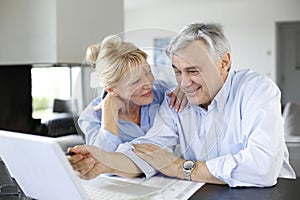 Senior couple connected with laptop