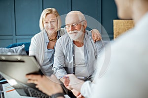 Senior couple with consultant at the office