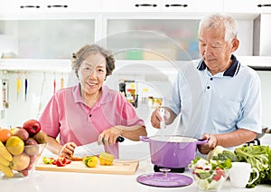 Senior couple cooking in kitchen