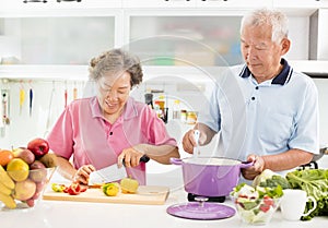 Senior couple cooking in kitchen