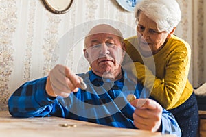 senior couple counting last cents medium shot living room money concept