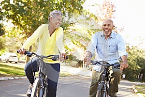 Senior Couple On Cycle Ride In Countryside