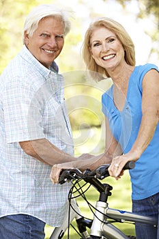 Senior Couple On Cycle Ride In Park