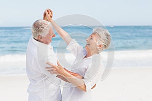 Senior couple dancing on the beach