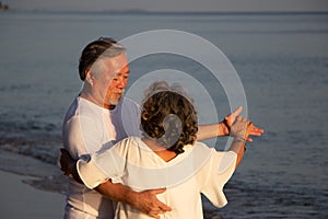 Senior couple dancing on beach.elderly travel leisure and activity after retirement in vacations and summer