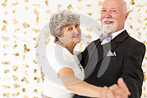 Senior couple dancing during birthday party