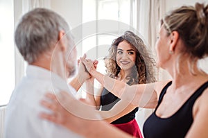 Senior couple in dancing class with dance teacher.