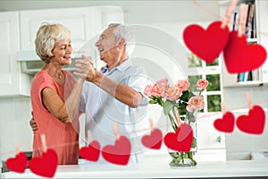 Senior couple dancing at home