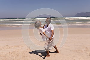 Senior couple dancing together on beach