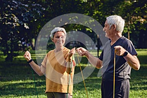 Senior couple doing exercises using resistance rubber bands