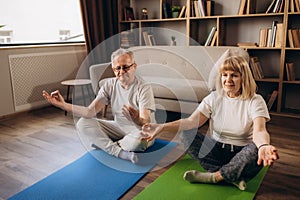 Senior couple is doing fitness training at home. Doing yoga together. Healthy lifestyle concept